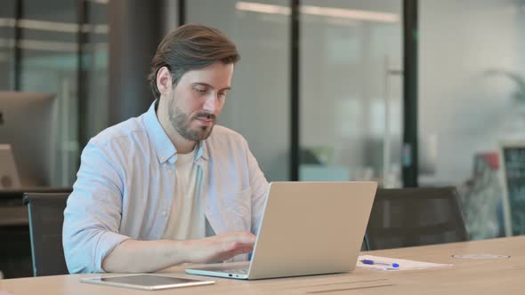 Mature Adult Man with Laptop Sleeping in Office