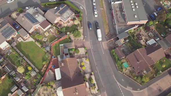 Bird's eye angle of traffic on a suburban British road wide shot