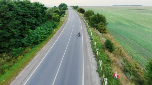 Man Riding Bike on Country Road