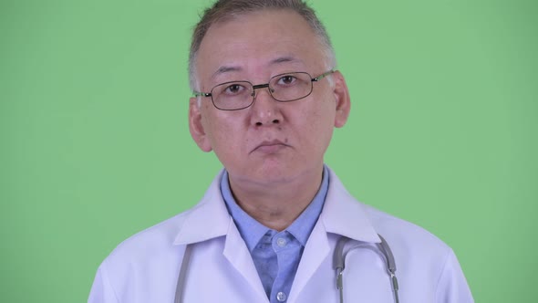 Face of Mature Japanese Man Doctor with Eyeglasses
