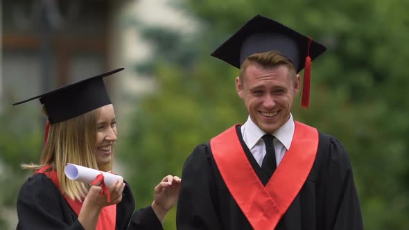 Young Beautiful Graduates Laughing With Diplomas in Hands, Successful Future