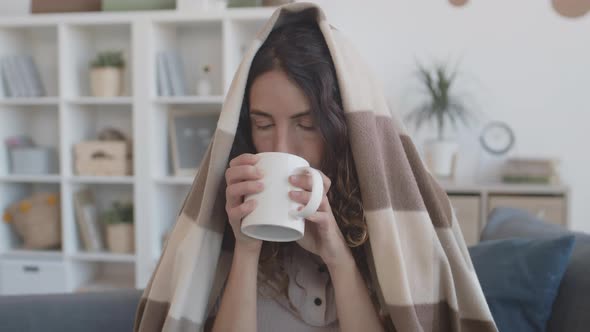 Woman Drinking Hot Tea and Sneezing