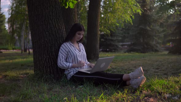 Freelancer Woman with Laptop in Park Distance Remote Working