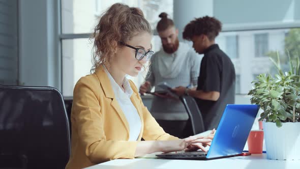 Successful Businesswoman Working at Laptop in Office