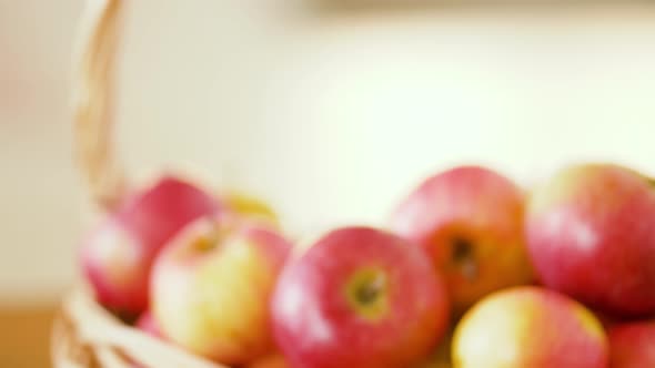 Apples in Basket and Glasses of Juice on Table 