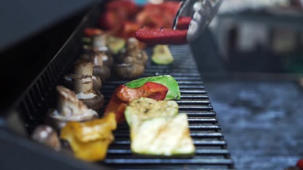 Cooking Mushrooms with Vegetables in Hot Seed Oil in a Frying Grill