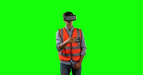 Front view of a site worker using virtual reality with green screen