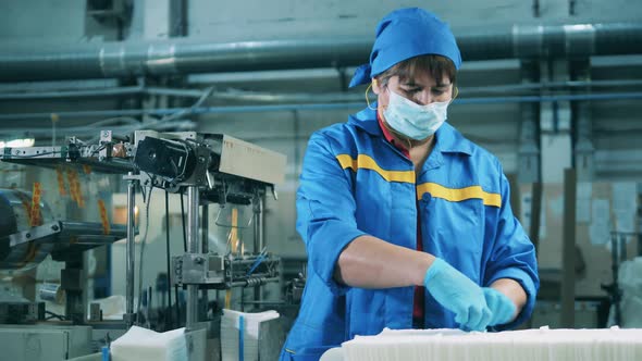 Female Worker Is Relocating Batches of Paper Tissues