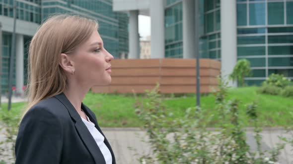 Close Up of Young Businesswoman Walking on the Street Side Pose