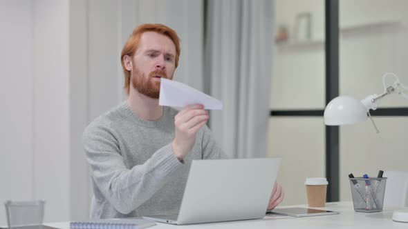 Redhead Man with Laptop Flying Paper Plane 