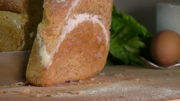 Loaf of Cereal Bread Falls on a Wooden Surface