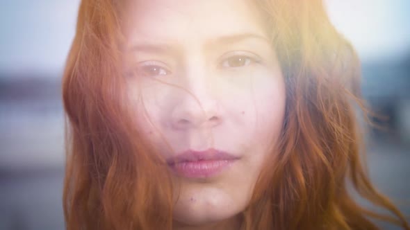  Beautiful Redhead Young Woman Looking at Camera Outdoors Sun Flares