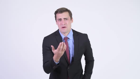 Young Angry Businessman Talking To Camera