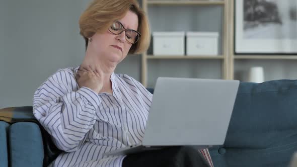 Old Senior Woman with Neck Pain Working on Laptop