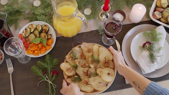 Unrecognizable Woman Setting Christmas Table