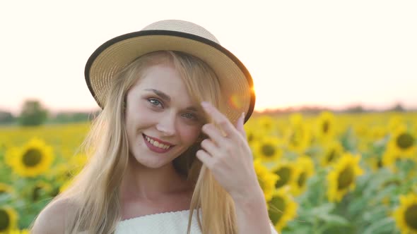 Happy Smiling Girl Smiling in Sunflowers Sun is in Background