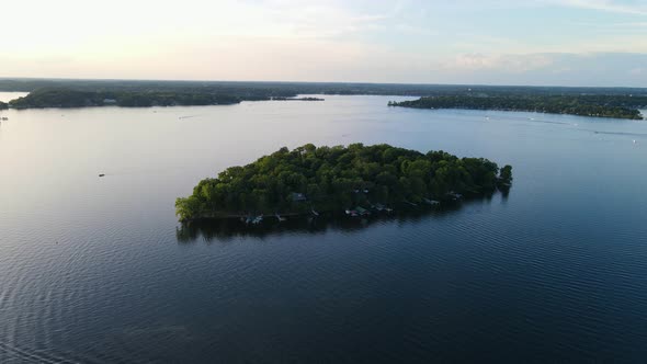 Aerial view of lonely island in the middle of a lake during summer time