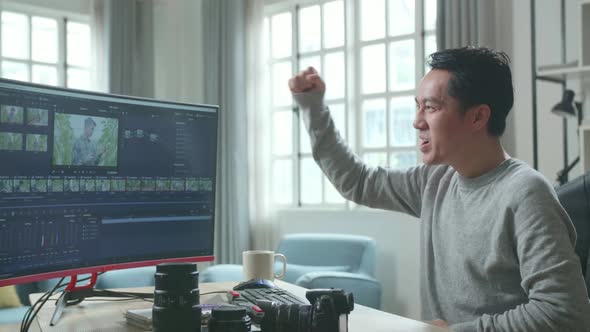 Asian Video Editor Man Being Happy Finishing Editing Video By Desktop Computer While Working At Home