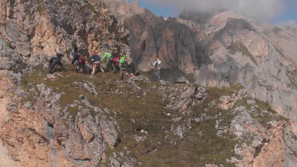 Aerial Shot of a Group of Climbers Pull the Rope