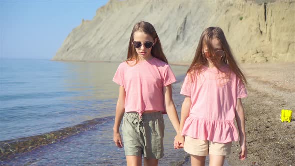 Adorable Little Girls Having Fun on the Beach