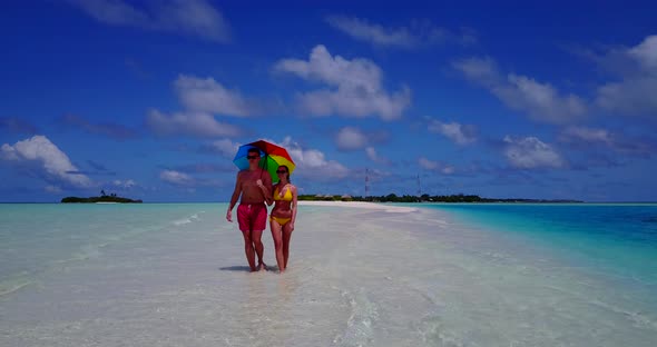 Happy lady and man on honeymoon vacation enjoy life on beach on paradise white sand 4K background