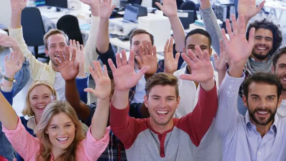 Portrait of business team gesturing together in office