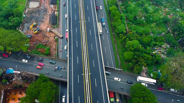 Aerial drone view of highway multilevel junction road with moving cars after rainy