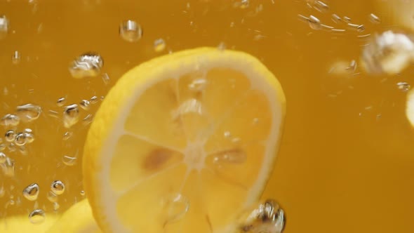 Ripe Lemons in Water on Yellow Background Making Cocktail of Citrus Fruits Cold Lemonade Shooting of