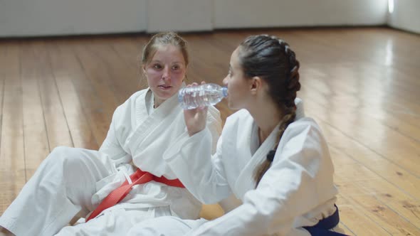 Handheld Shot of Girls Sitting on Floor After Karate Workout