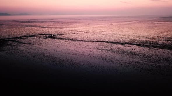 Low tide aerial view on foreshore at sunset.