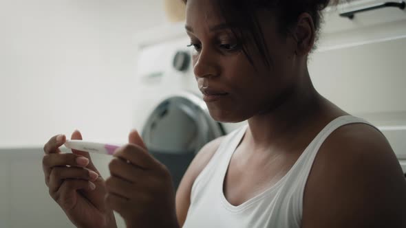 Close up of African-American stressed woman  waiting for pregnancy test results. Shot with RED heliu