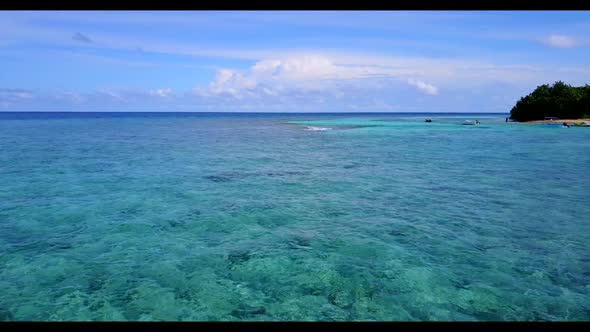 Aerial above sky of tranquil seashore beach trip by blue ocean and white sandy background of a picni