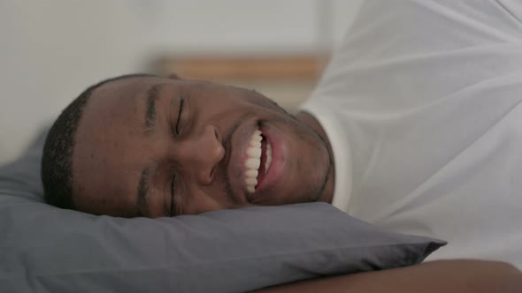 Close Up African Man Talking on Video Call While Sleeping in Bed