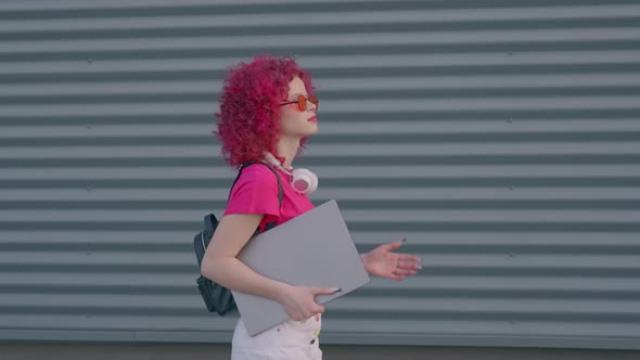 A Pink Curly Woman is Walking to Work or College alt