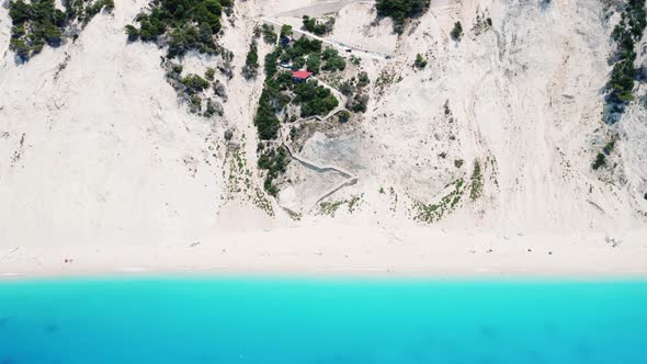 Drone view of scenic beach with white sand and turquoise sea, Greek islands.