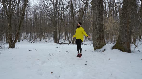 Bearded Fit Man Skipping with Jumping Rope in Winter Forest