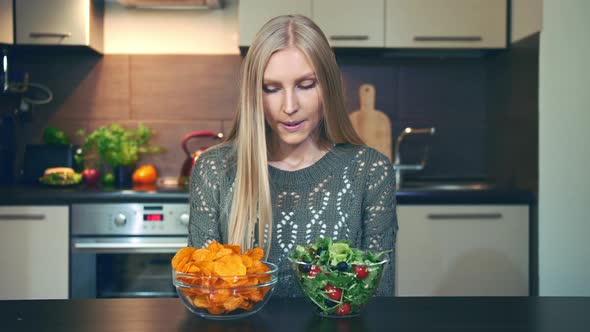 Young Woman Preferring Salad To Crisp