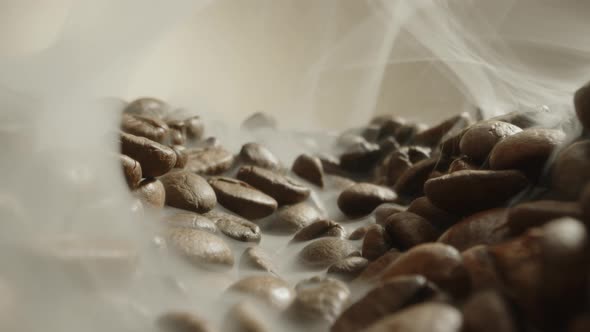 Slow Dolly in Footage Near Roasted Coffee Beans with Smoke Freshly Brewed Coffee Beans with Smoke