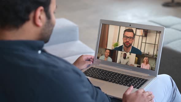 Multiethnic Hindu Freelancer Guy Using Laptop Computer for Video Call