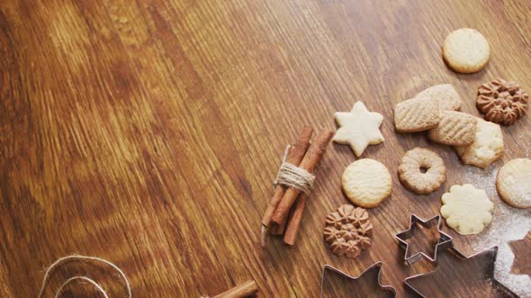 Video of christmas decorations with cookies and copy space on wooden background