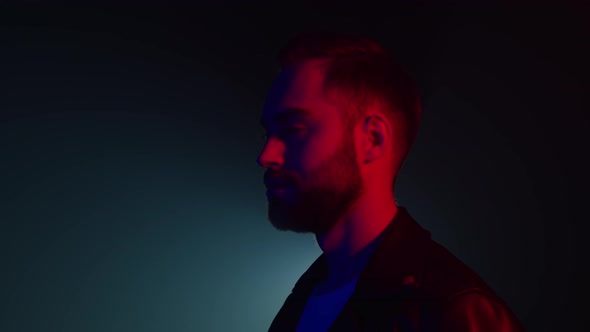 Portrait of Caucasian Man with Beard in Leather Jacket Illuminated Neon Light