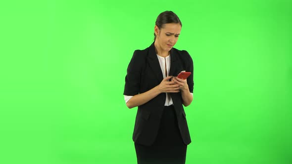 Girl Angrily Texting on Her Phone. Green Screen