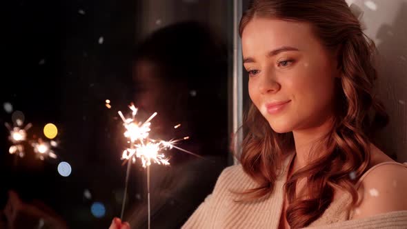 Happy Young Woman with Sparklers at Home
