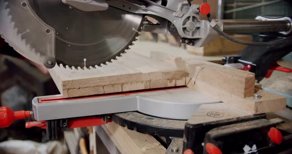 Slow Motion Close Up the Master Cuts a Wooden Board with a Circular Saw in the Woodworking Workshop