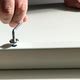 A Man a Handyman in a Blue Shirt Collects a Table Closeup - VideoHive Item for Sale