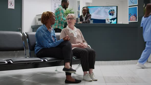 Diverse Female Patients Sitting in Hospital Waiting Area