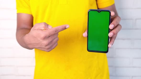 Close Up of Young Man Hand Using Smart Phone with Green Screen