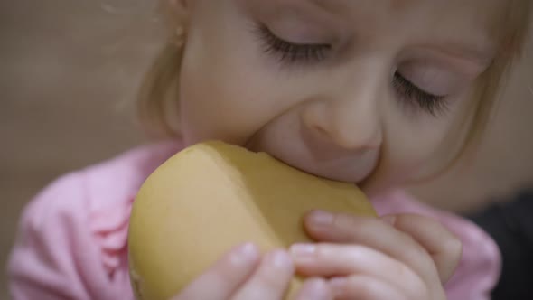 Beautiful Happy Hungry Baby Girl Eating Hamburger. Concept Child with Fast Food