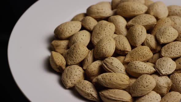 Cinematic, rotating shot of almonds on a white surface - ALMONDS 