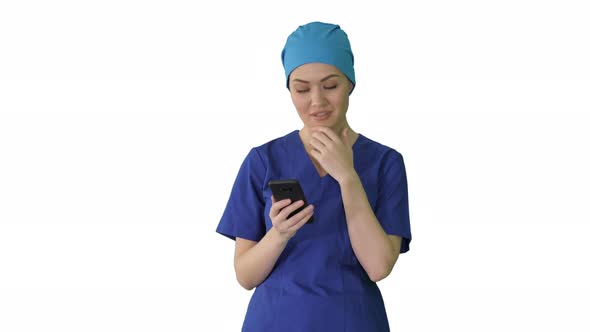 Thinking Female Doctor Using Her Smartphone on White Background